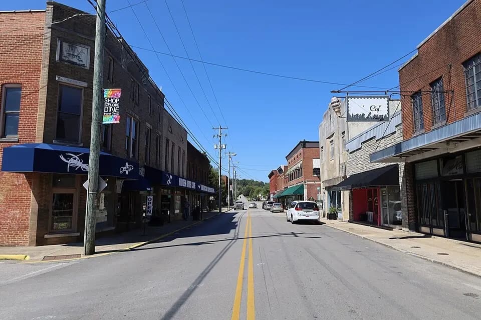 Real photograph looking along Main Street and historic brick storefronts in Horse Cave, Kentucky.